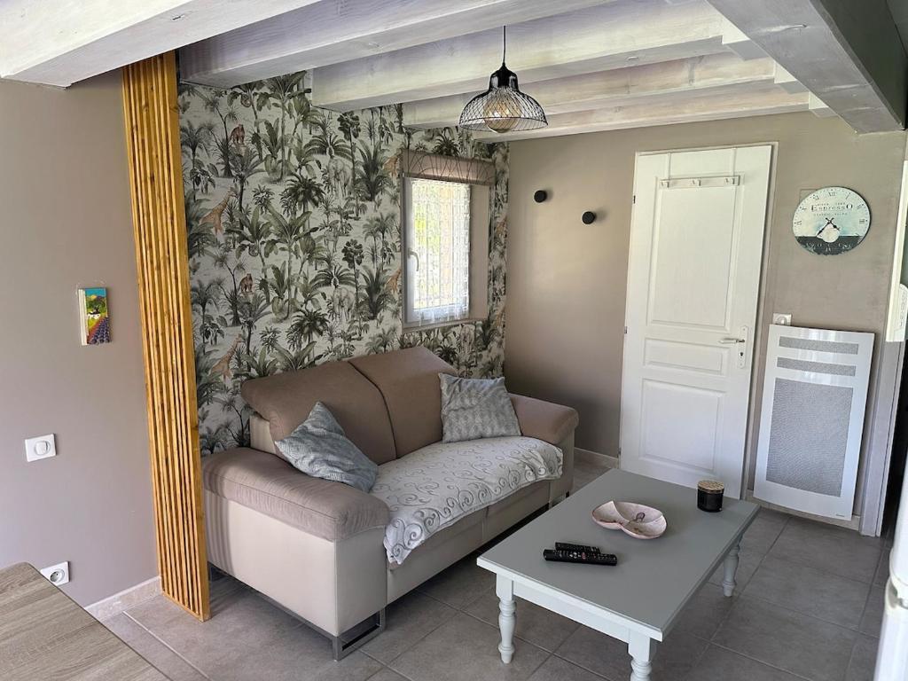 un salon avec un canapé et une table dans l'établissement Charming outbuilding with pool in Peypind'Aigues, à Peypin-dʼAigues