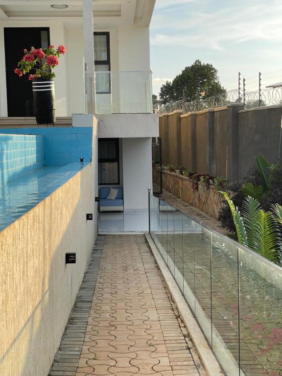a house with a swimming pool and a balcony at Infinity Villas 1 Superking bed Studio Apartment free parking , WiFi , 24 hr security in Entebbe