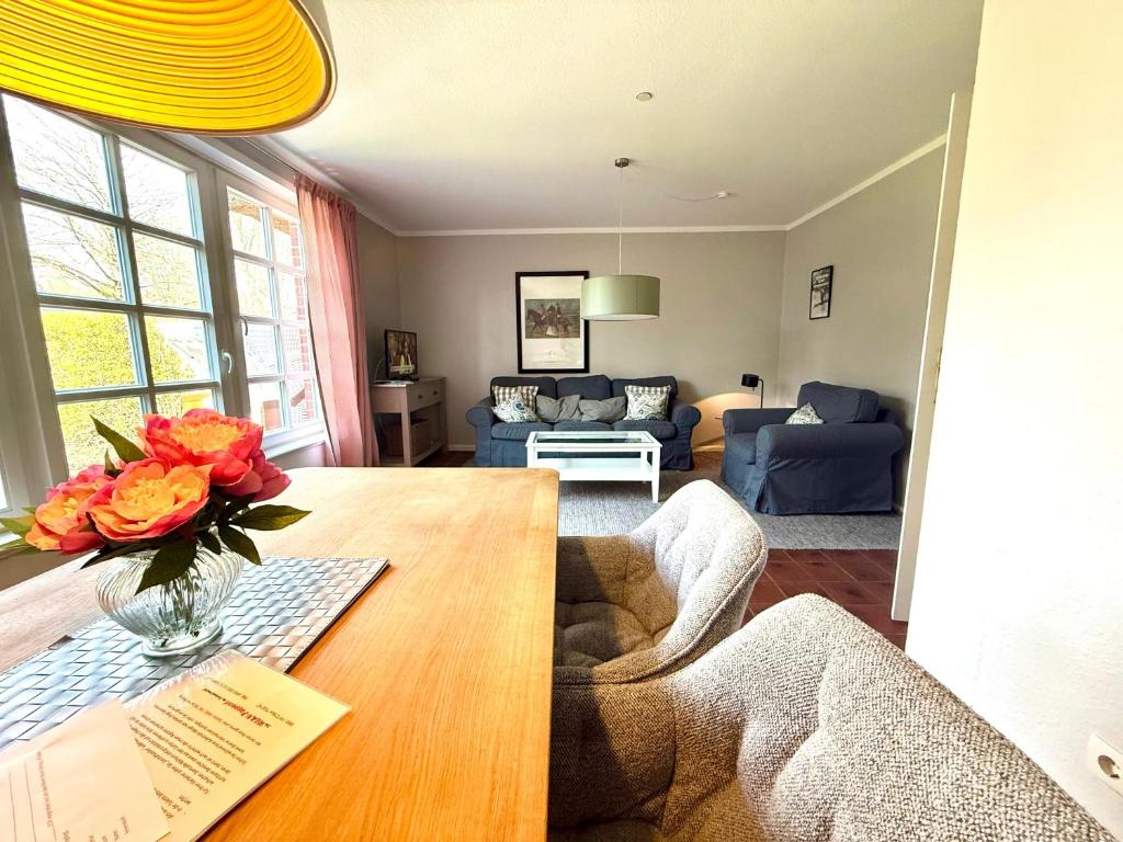 a living room with a table with flowers on it at Haus Friesenfeuer in Nieblum