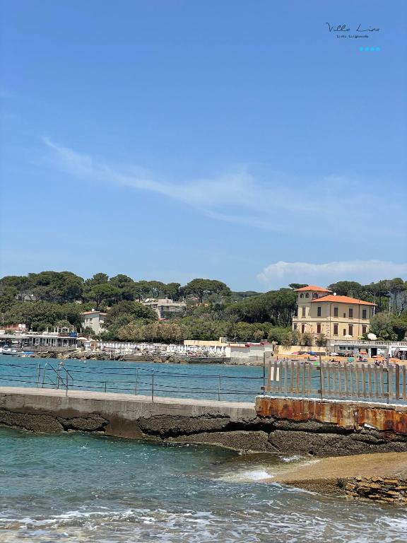 a bridge over a body of water next to a beach at Villa Lina in Castiglioncello