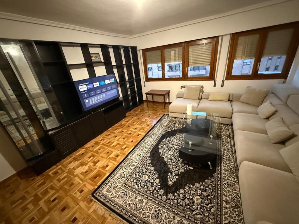 a living room with a couch and a flat screen tv at Casa val in Valdemoro