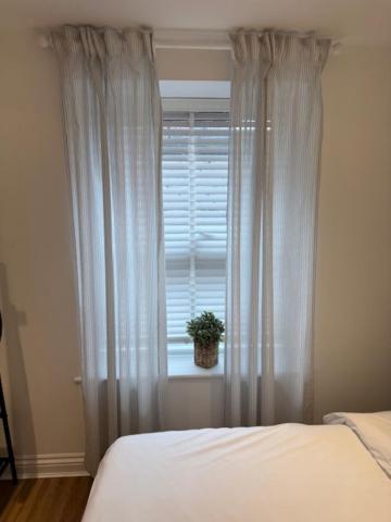 a bedroom with a bed and a window with a potted plant at Valletta House Holiday Apartments in Skegness