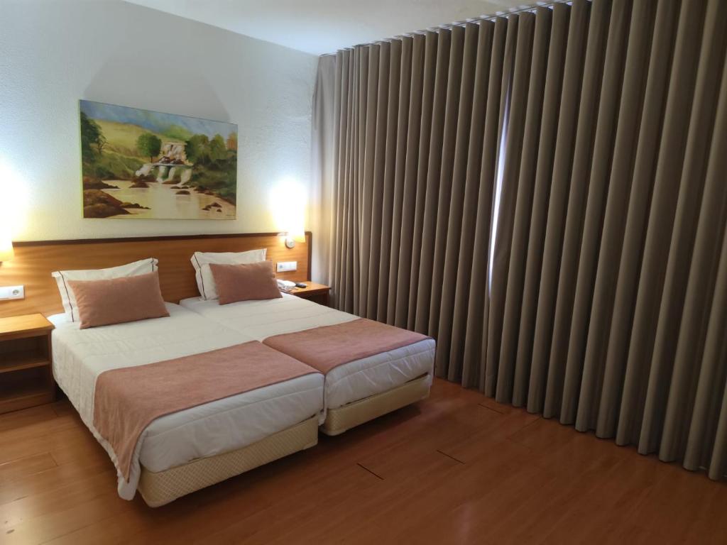 Postel nebo postele na pokoji v ubytování Hotel Dom Vilas