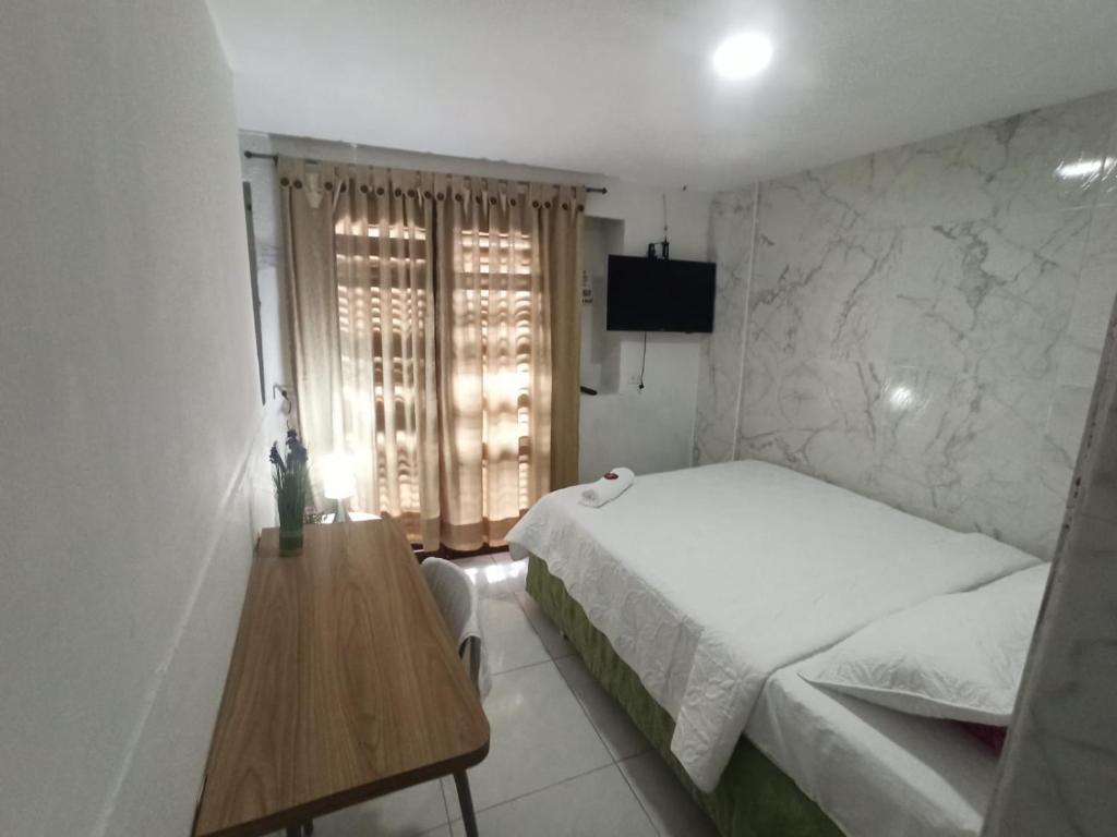 Postel nebo postele na pokoji v ubytování Hostal Casa de las Americas