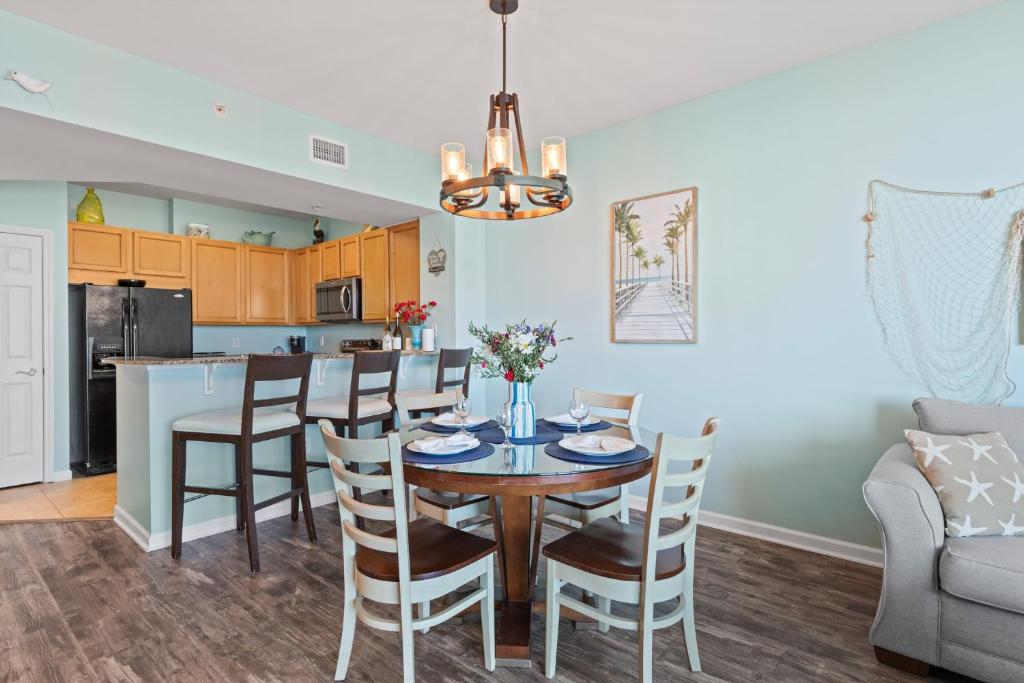 a kitchen and dining room with a table and chairs at 5 Star Resort 11th Fl Stunning Sunrise 2BR 2BA King Suite,Pools ,Shuttle or Walk to Beach in Destin
