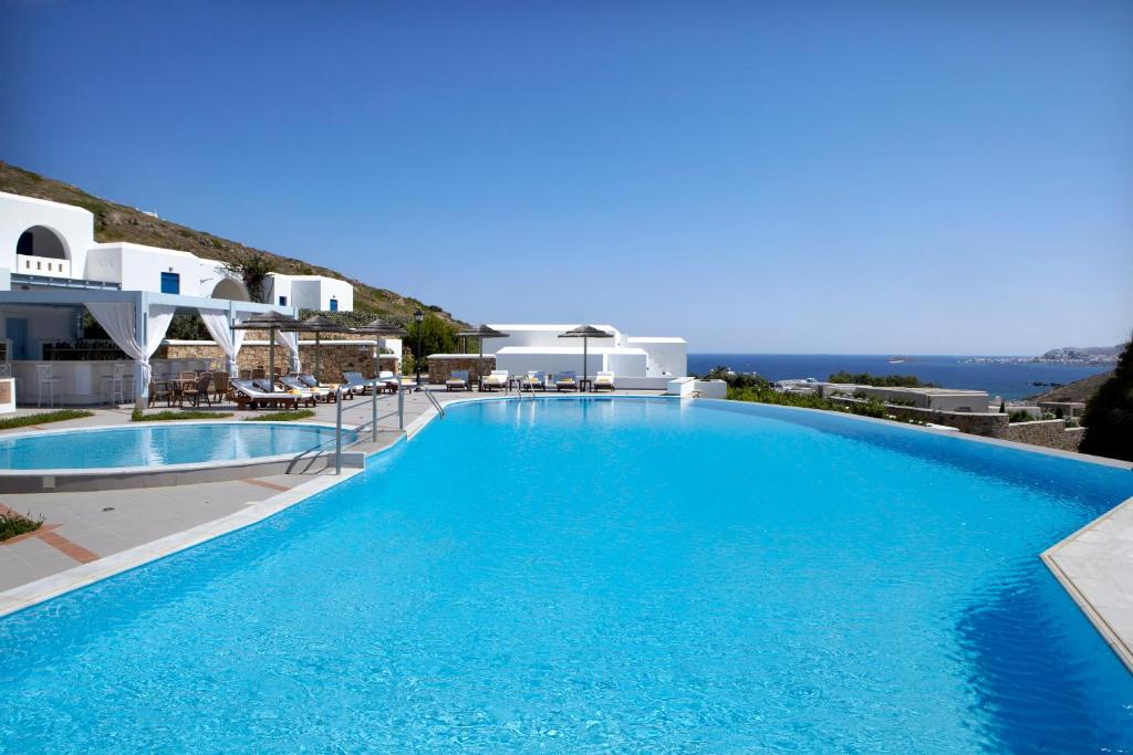 a large swimming pool with a view of the ocean at Hotel Mediterranean in Stelida