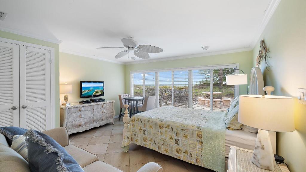 a bedroom with a bed and a tv and a couch at Las Hermanas 4 in Longboat Key