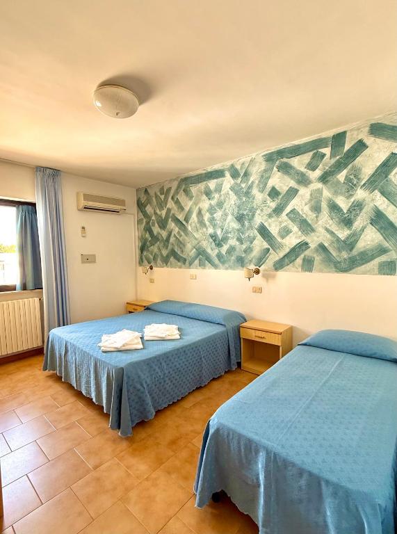 Ένα ή περισσότερα κρεβάτια σε δωμάτιο στο Hotel Timiama