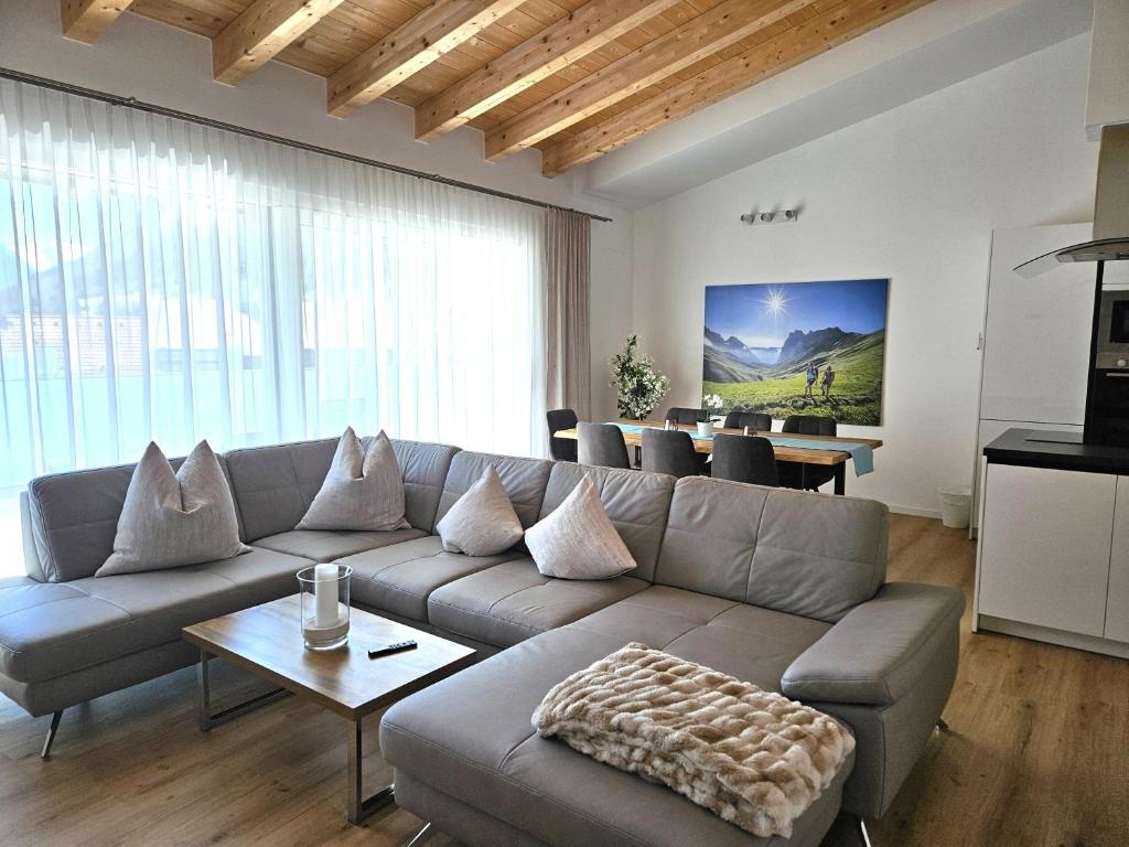 a living room with a couch and a table at Appartements am Kirchplatz in Fulpmes