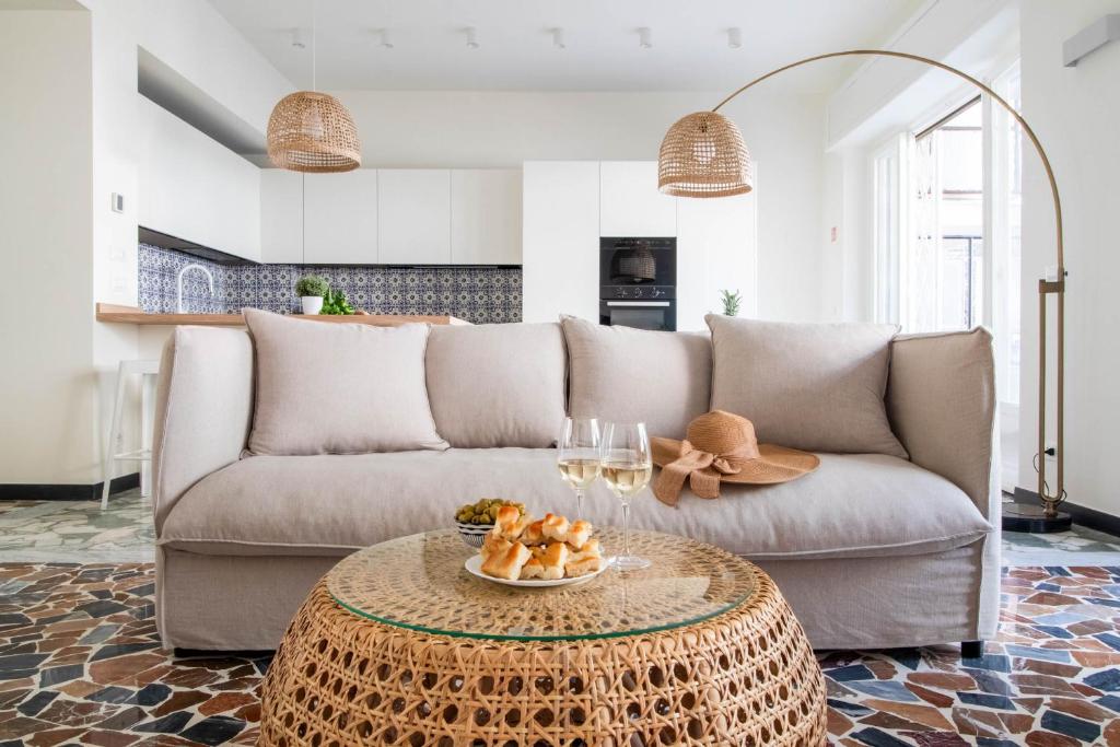 a living room with a couch and a table at Casa Alyx by PortofinoHomes in Santa Margherita Ligure