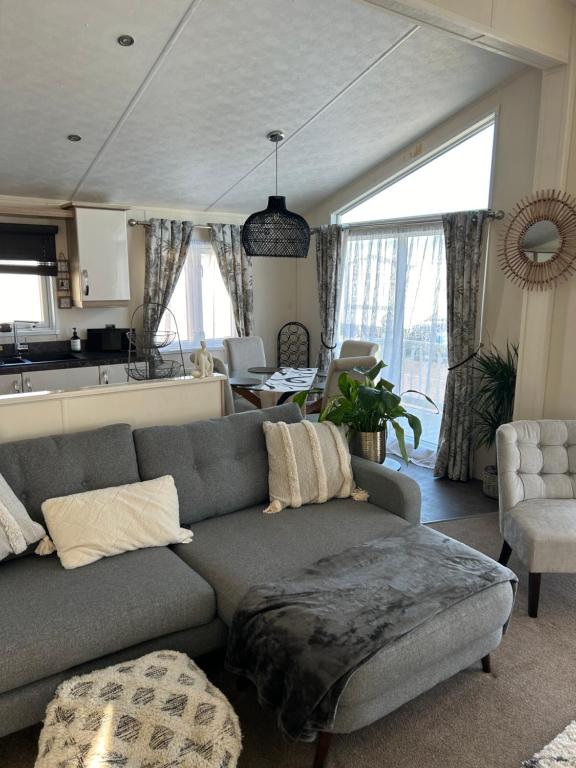 a living room with a couch and a kitchen at Kent Getaways in Westgate-on-Sea
