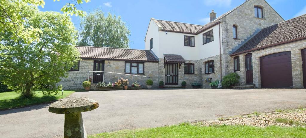 a large brick house with a driveway at Guest Suite King Bed in Chew Valley Bath Somerset in Chew Magna