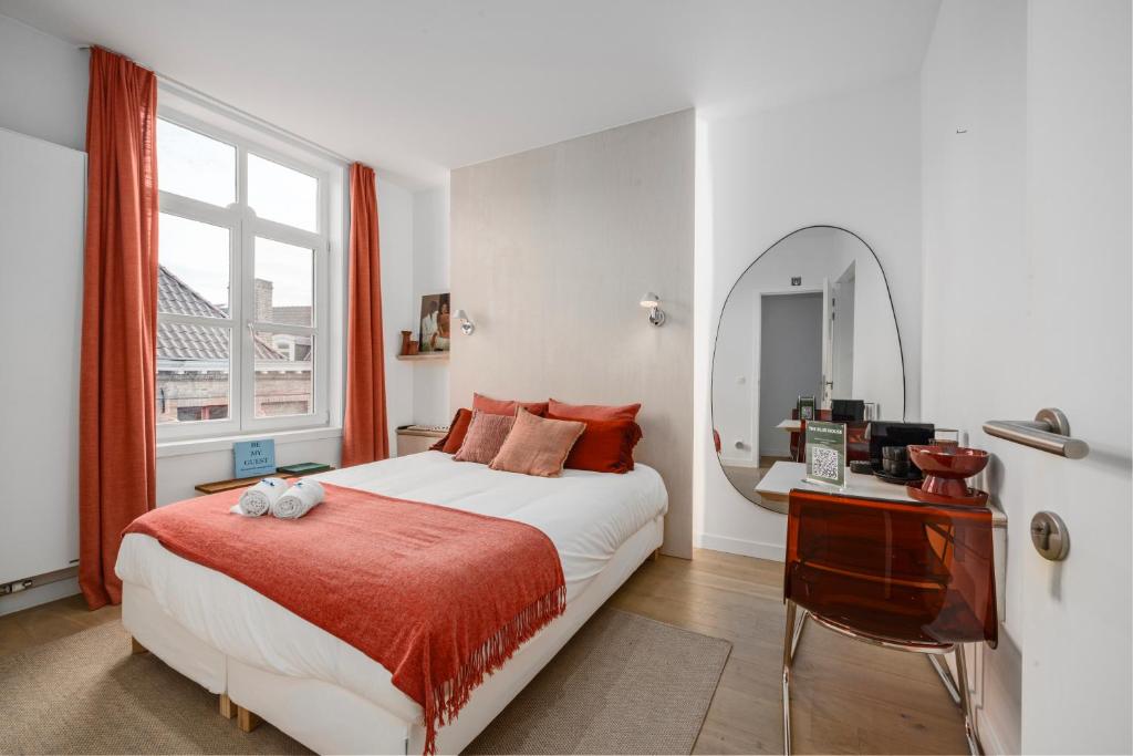 a bedroom with a bed with a mirror and a desk at THE BLUE HOUSE - Guest Suite 1 in Bruges