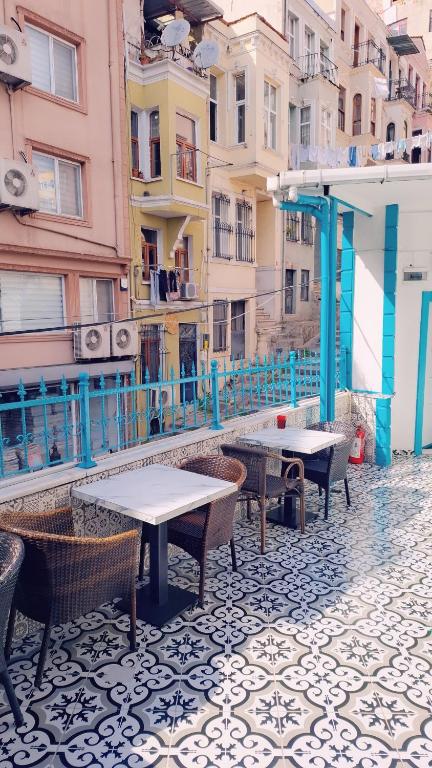 a group of tables and chairs on a street with buildings at Old City Pansiyon in Istanbul