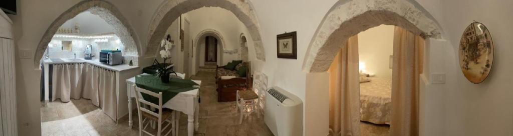 a hallway with arches in a home with a kitchen at Il Trullo L'amore di Nonna in Martina Franca