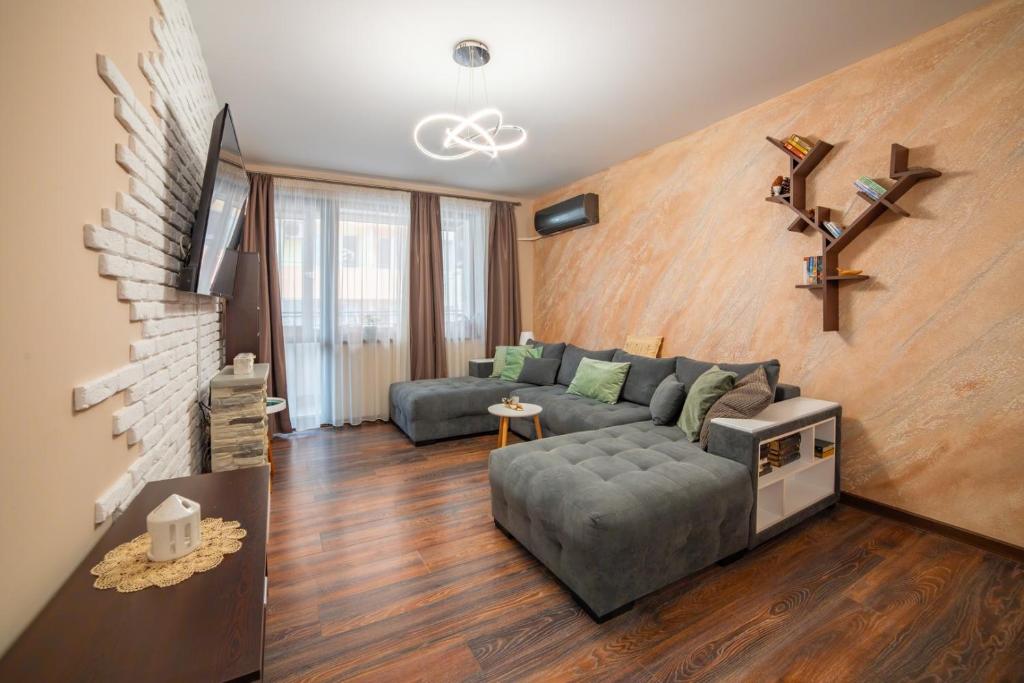 una sala de estar con un sofá y una mesa en Tarnovo Nest | Cozy 1BR Apartment, en Veliko Tŭrnovo