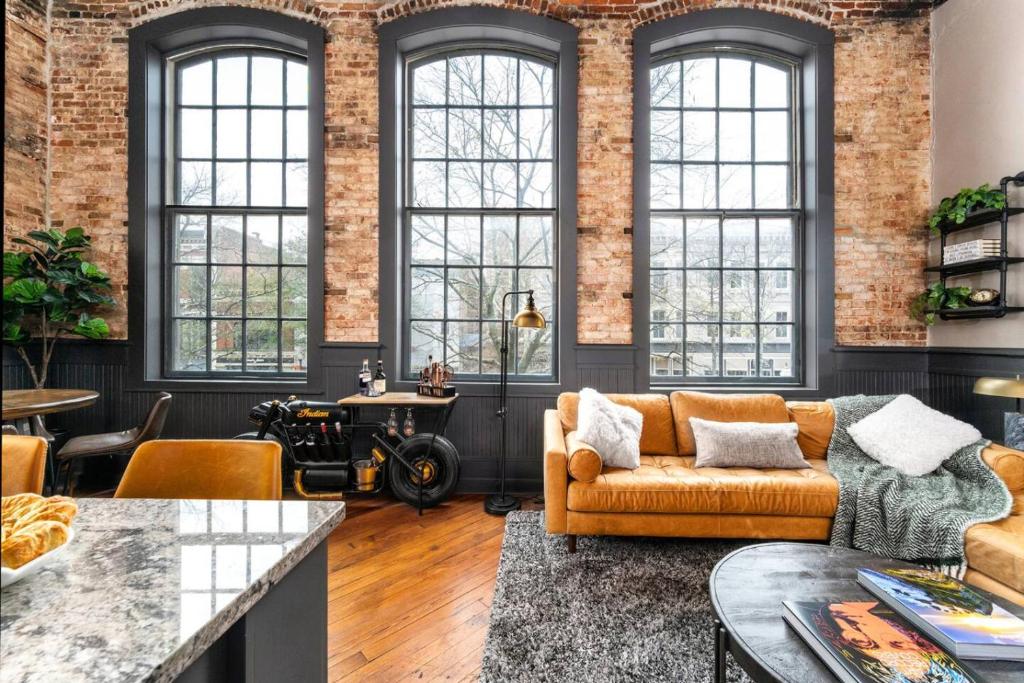 a living room with a couch and a table at 547 Cherry Loft 201 - The Rookery - Luxe Property in Macon