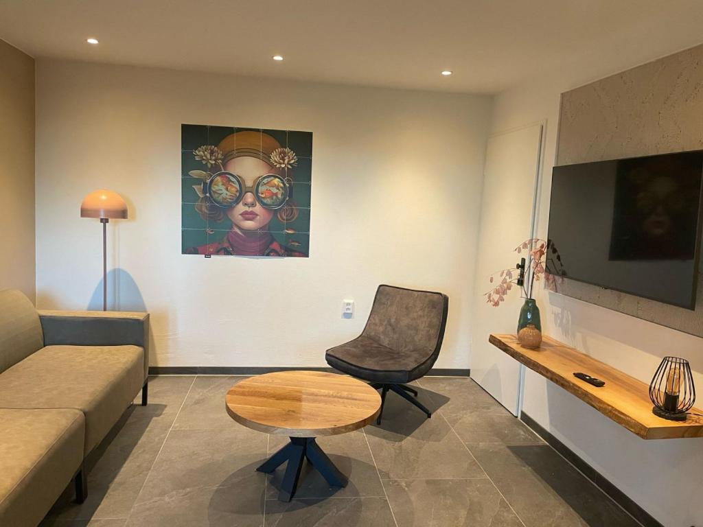 a living room with a couch and a chair at Valley View Cottage 4 Authentic 6 guest cottage near Valkenburg in Voerendaal