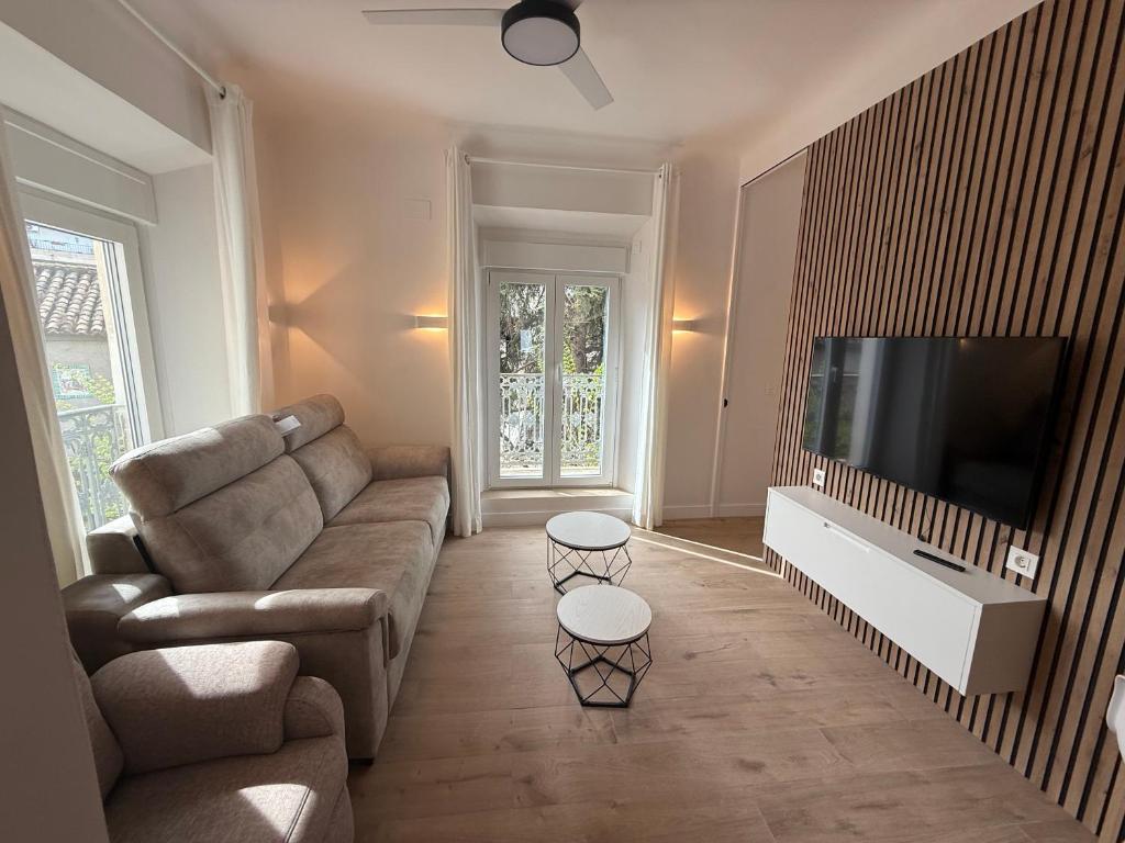 a living room with a couch and a flat screen tv at La Sorpresa in Huétor Vega