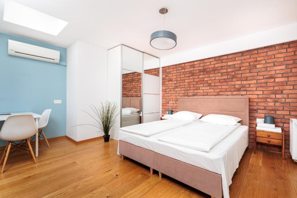 Posteľ alebo postele v izbe v ubytovaní Olimp Apartments