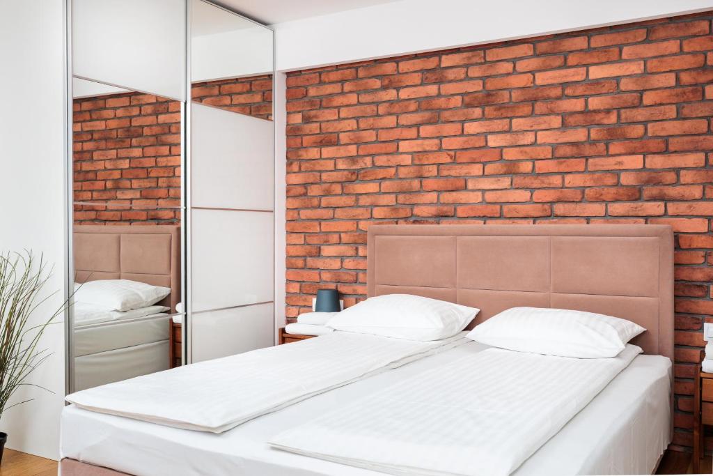 Posteľ alebo postele v izbe v ubytovaní Olimp Apartments