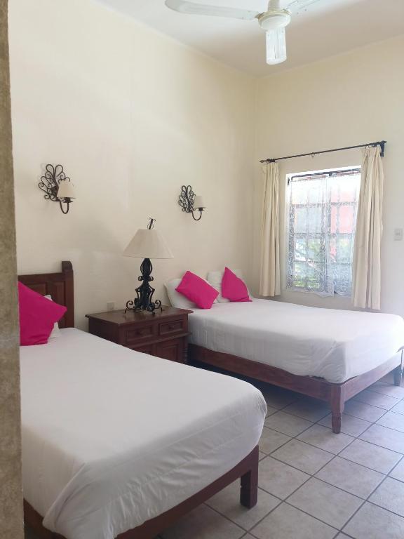 Postel nebo postele na pokoji v ubytování Hotel Quinta Loreto