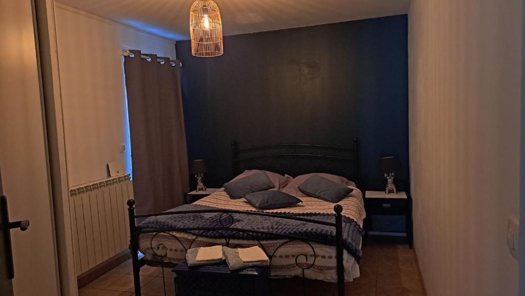 a bedroom with a bed with two pillows on it at Les 2 étangs de la Foulonnerie in Saint-Jean-Saint-Germain