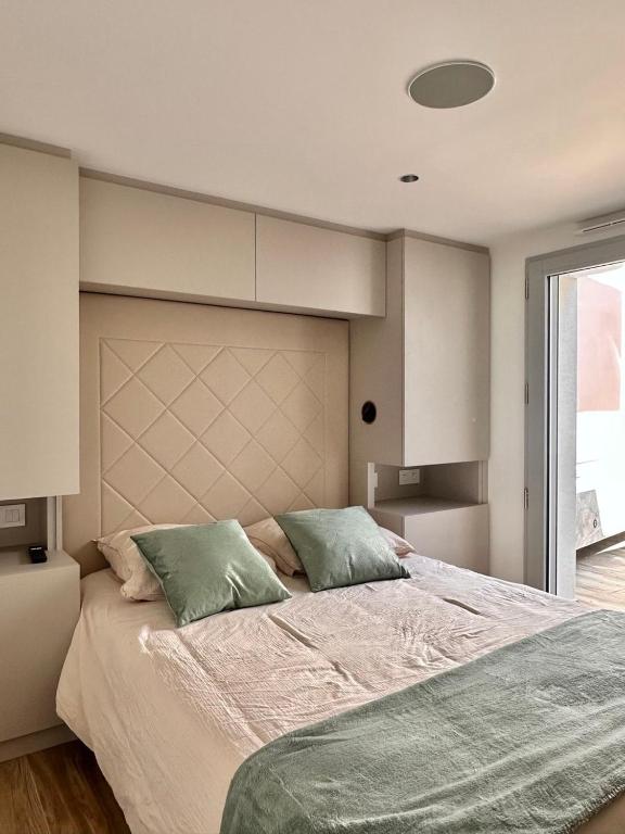 a bedroom with a large bed with two pillows at Le Clos de la Côte Sauvage in Piriac-sur-Mer