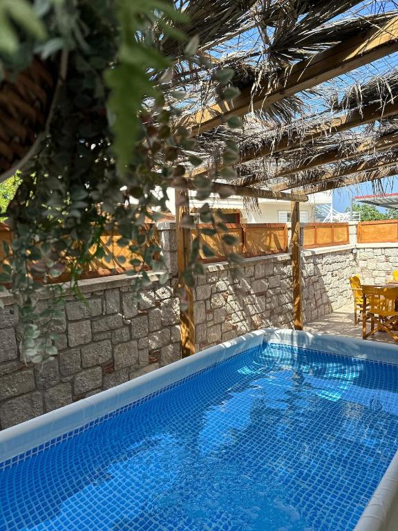 a large swimming pool in a yard with a house at Levante Apartment for 4 in Faliraki