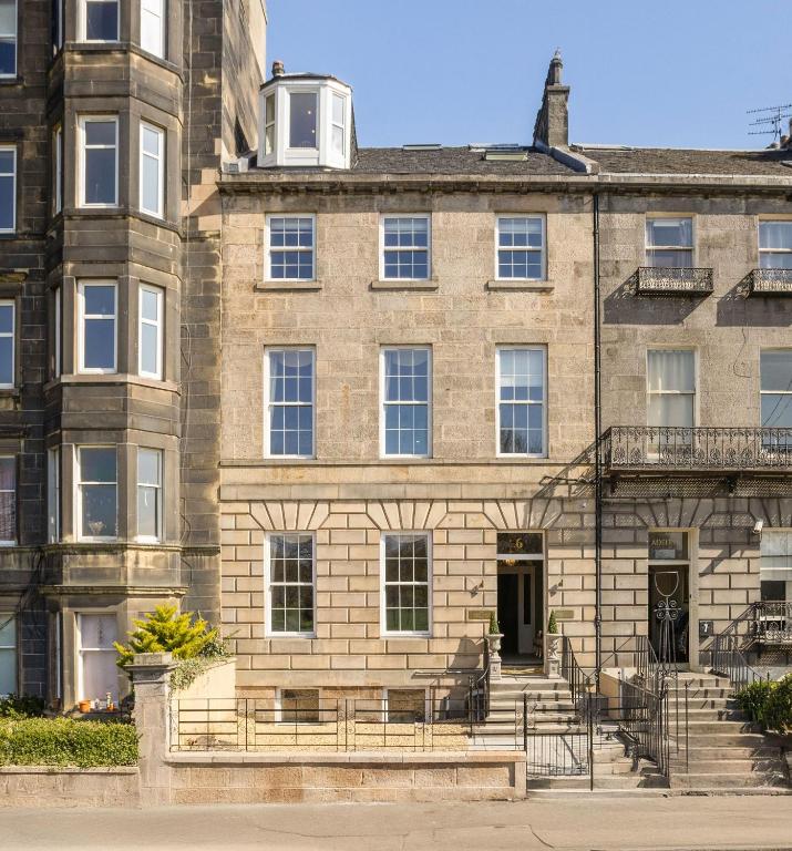 a large brick building with a staircase in front of it at The Townhouse, Leith in Edinburgh