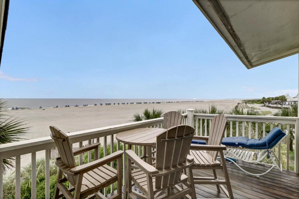 a patio with chairs and a table on the beach at Seagrove 11D by Wild Dunes, Oceanfront Condo in Isle of Palms