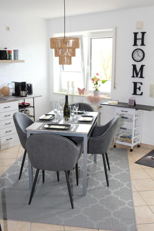 a dining room with a white table and chairs at La Casa in Medebach