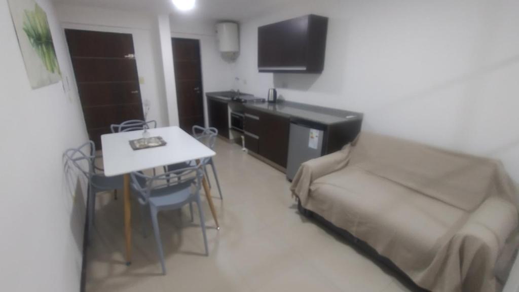 a small living room with a couch and a table at Franco l in Posadas