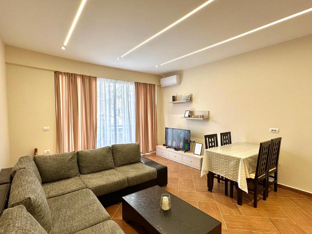 a living room with a couch and a table at Elisabeth Apartments 3 in Sarandë