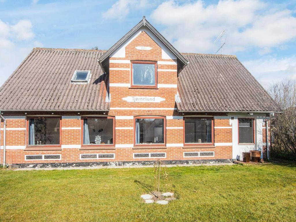 a brick house with windows and a roof at 8 person holiday home in Bindslev-By Traum in Bindslev