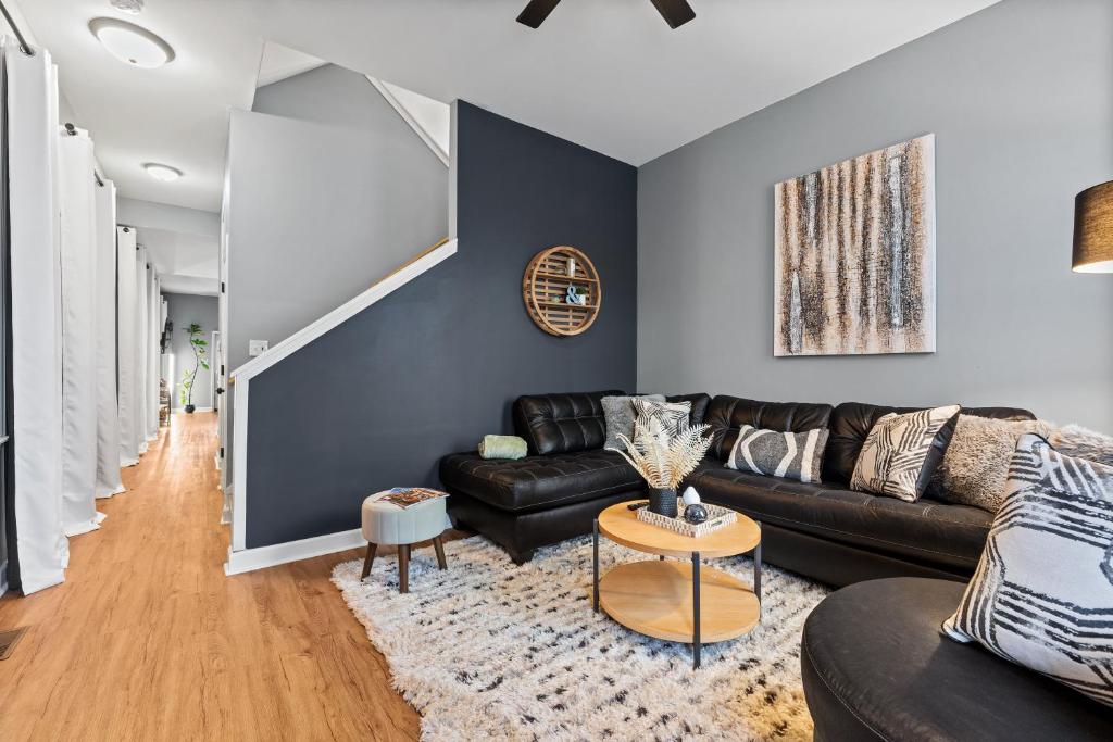 a living room with a couch and a table at The Journey Home | JZ Vacation Rentals in Soulard