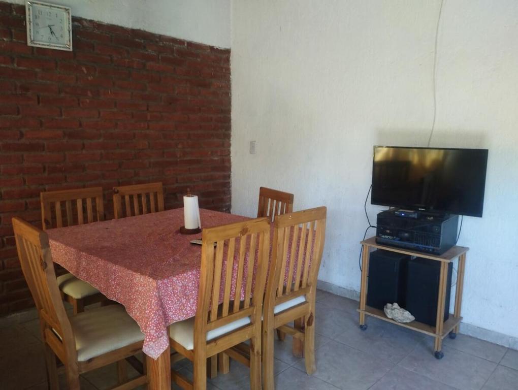 a dining room with a table and a television at Casa doña tati in Cortaderas
