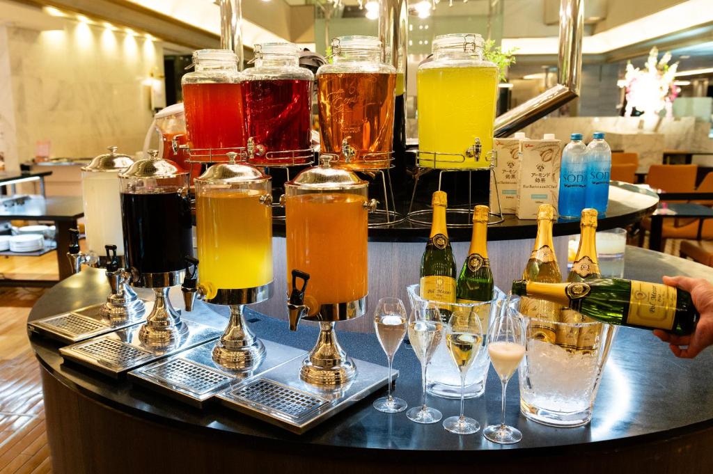 a bar with a bunch of different types of drinks at Hotel Granvia Osaka-JR Hotel Group in Osaka