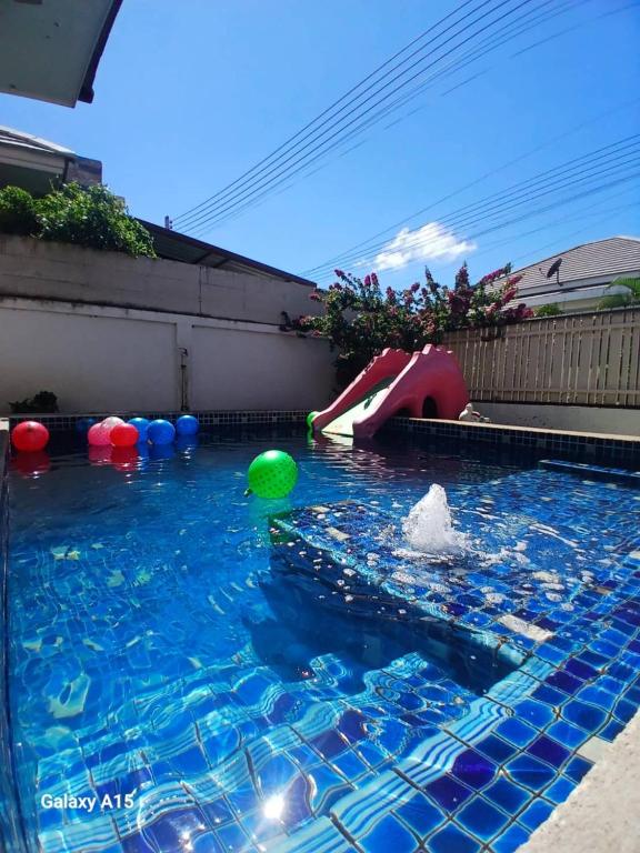 a pool of water with a slide and a playground at The Guestvilla644 in Hua Hin