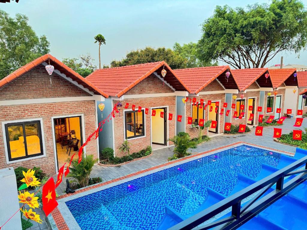 a house with a swimming pool in front of it at Tràng An ChiDu Homestay in Ninh Binh