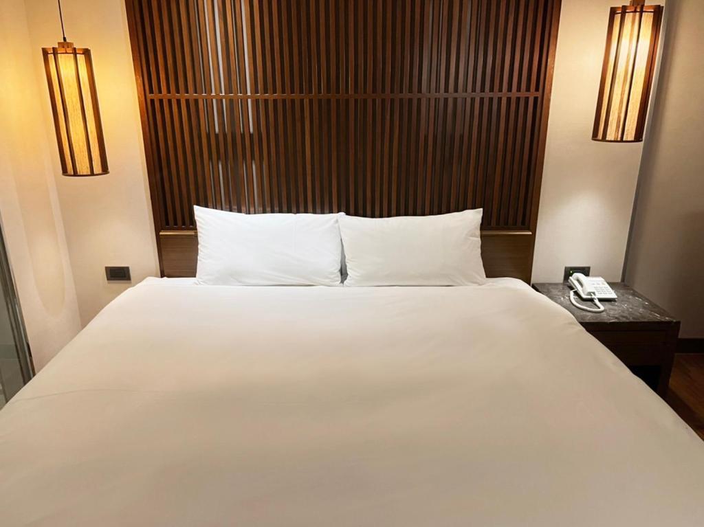 Postel nebo postele na pokoji v ubytování Guide Hotel Taipei Bade