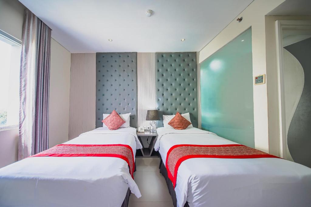 Postel nebo postele na pokoji v ubytování Serela Cihampelas by KAGUM Hotels