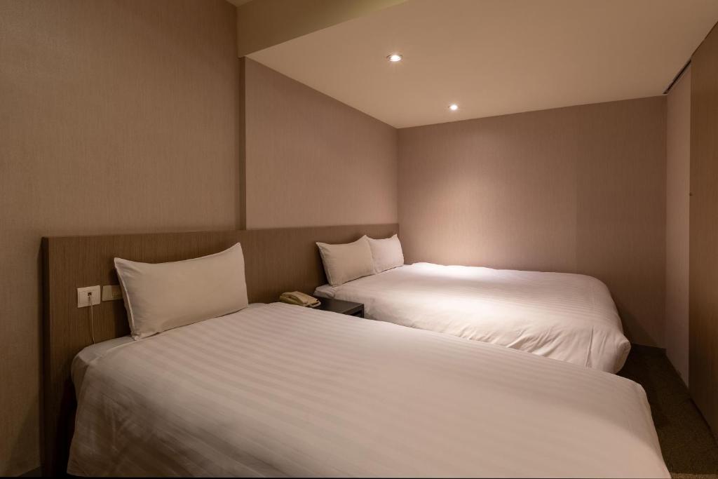 Postel nebo postele na pokoji v ubytování Guide Hotel Taipei Chongqing