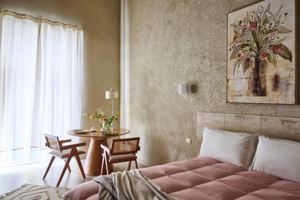 a bedroom with a bed and a table and a window at FUTURA ROOM&RELAX in Termoli