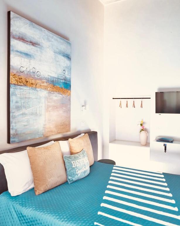 a bedroom with a bed with a blue blanket at FUTURA ROOM&RELAX in Termoli