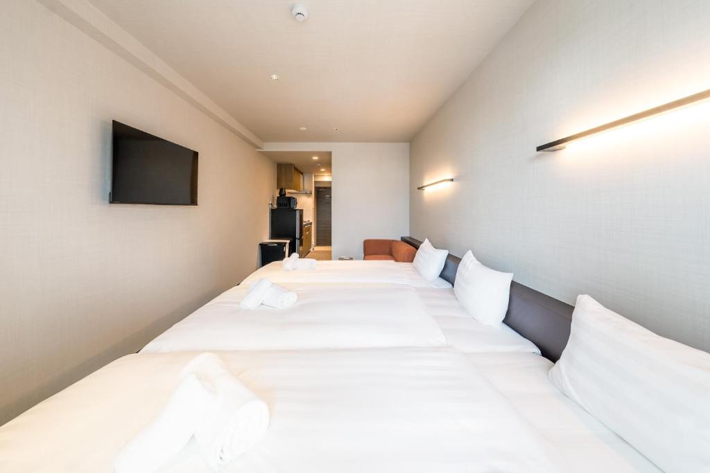 Apartment Hotel 11 Miyakojimaにあるベッド