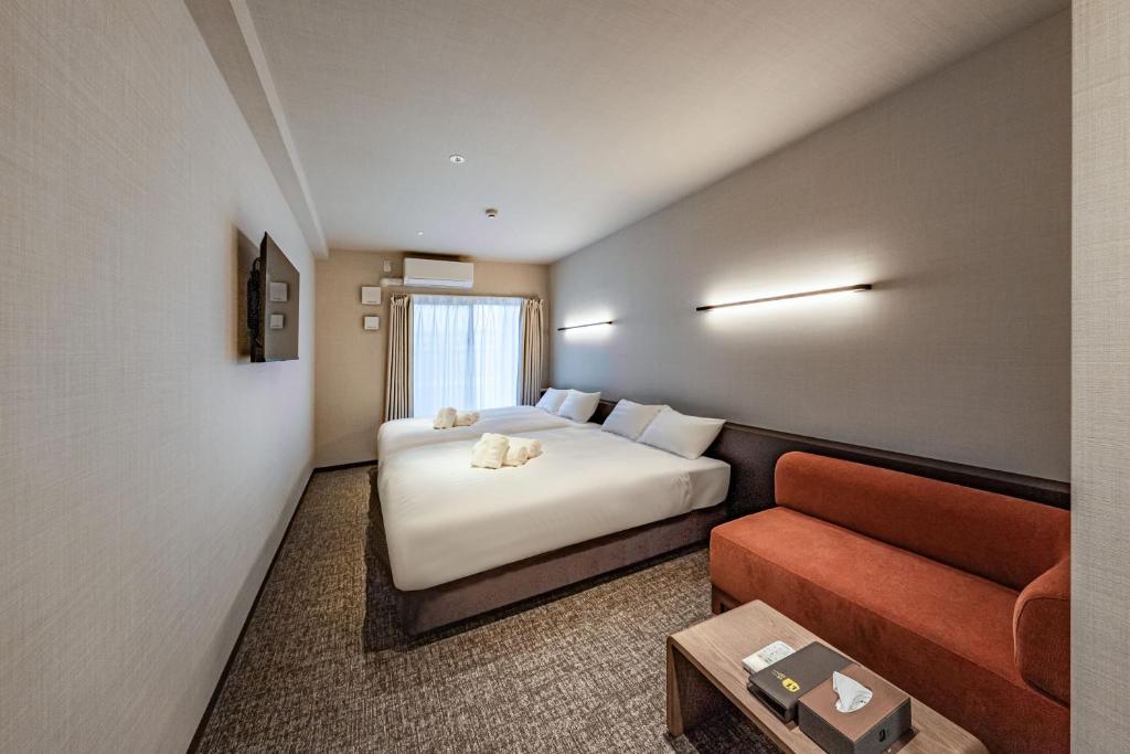 Apartment Hotel 11 Miyakojimaにあるベッド