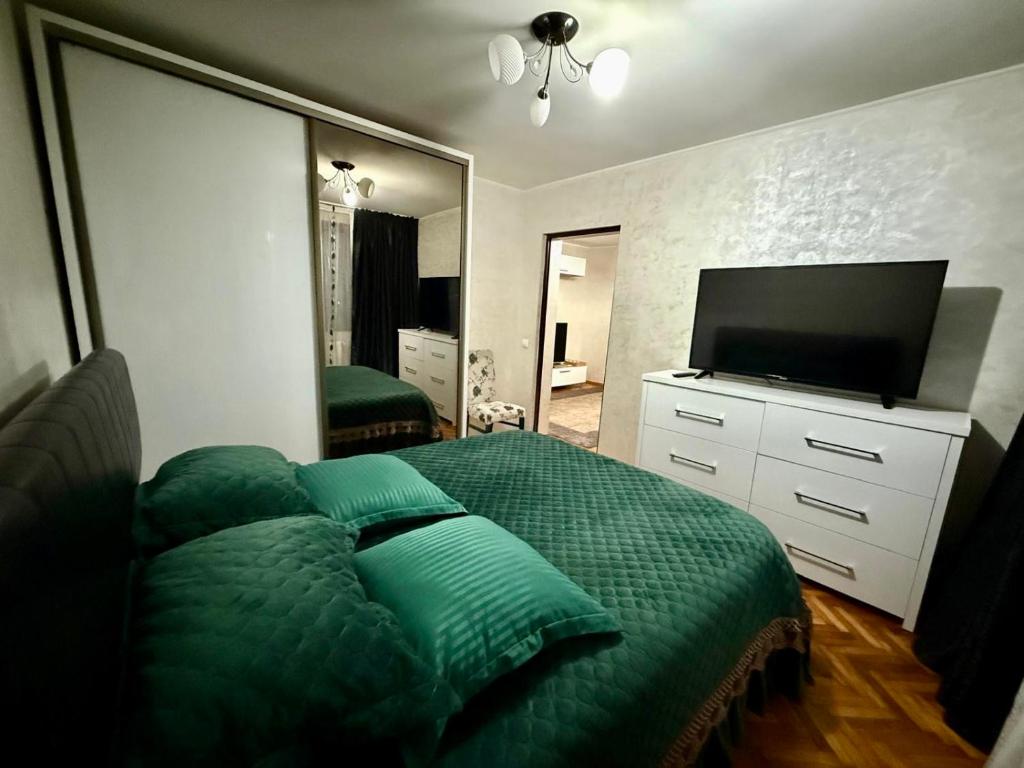 ein Schlafzimmer mit Bett und Flachbildfernseher in der Unterkunft Zen Apartment in Galaţi