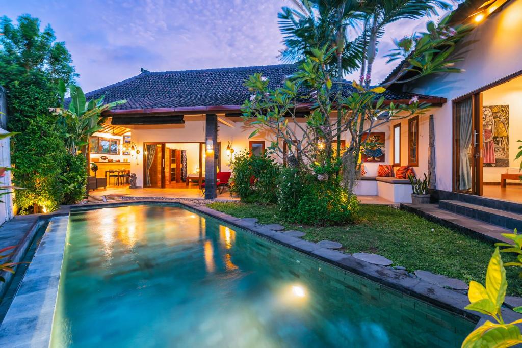 a swimming pool in the backyard of a house at Villa Moringa 2 - Private Villa in the Heart of Canggu, 5 Minutes from the Beach in Canggu
