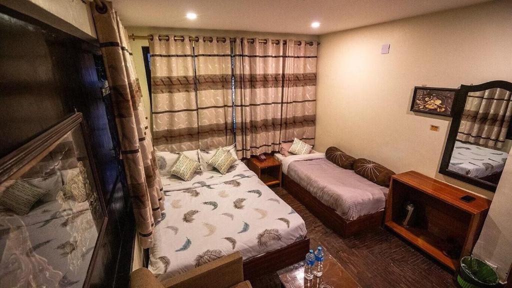 Postel nebo postele na pokoji v ubytování Hotel Shree Tara